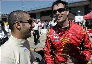 Tony Kanaan, left, congratulates Firestone 400 pole winner Bryan Herta.