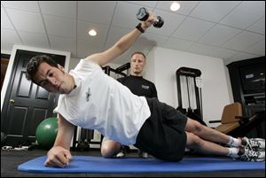 Sam Hornish Jr. works out in his Napoleon home for trainer Jim Leo of PitFit Training. 