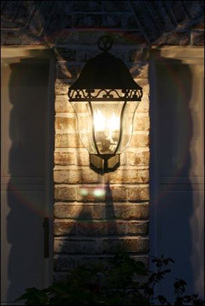 A fixture illuminates garage doors at the home of Katie and Steve Branam.