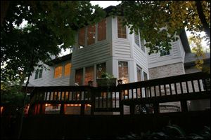 
Steve and Katie Branam have kept many trees in their backyard to remind them of their lake house in northern Michigan. The Branams have numerous lights hanging from trees, and rope lighting around the deck.