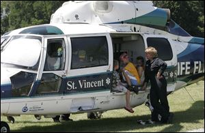 NBR  lyons 30p  Lyons Ohio.  Lyons Community Park. A celebration including volleyball and baseball and BBQ chicken dinners.   l-r  Aidan Tompkins, Morenci, Hunter Hooks, Oregon, Ohio, Daniel Michael, Fayette and  Life Flight RN Mary Schafer.  The boys were hanging out  talking.  Daniel knew the nurse because he was lifeflighted  several years ago. NOTE:  I didnt make it for the parade.   The Blade/Diane Hires  7/30/04