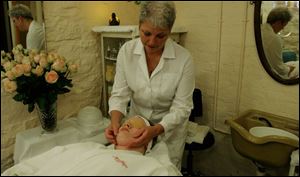 Kate Harvie of New York City receives a facial from Jan Archambeau at the Kerr House.