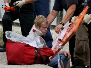 Paramedics treat Richard Cole, 24, who was rescued from the Maumee River near I-280.