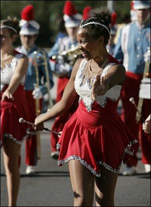 McKenzie Gregory, a majorette with South Toledo s Bowsher High School Marching Band, performs in the parade.
