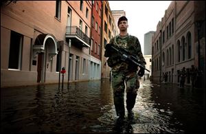 Sgt. Robert Stanley of the 82nd Airborne Division patrols the flooded streets of New Orleans after Hurricane Katrina struck.