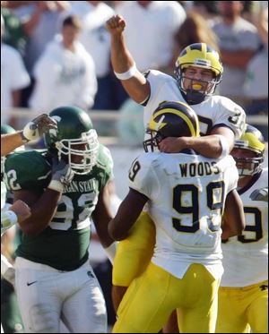 Garrett Rivas gets a lift after his 35-yard field goal in overtime lifted Michigan to a win over Michigan State.