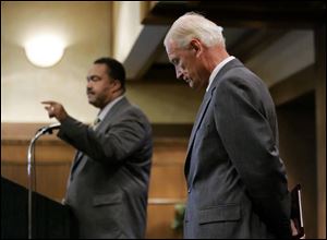 Mayor Jack Ford makes a point while former mayor Carty
Finkbeiner listens during a question-and-answer period.
They were at a Toledo Board of Realtors candidates  forum.