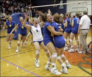 Emily Florian, right, gets a hug from her sister, Allison, as teammates Alliya Drzewiecki (9), Katelyn Schissler (6) and Tighe Westrick
rush to join the celebration after the Arrows won the City League championship match last week against Central Catholic.
