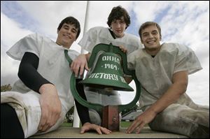 Quarterback Sam Miller, left, lineman Eric McChesney and running back Matt Netter think earning a playoff spot tonight has a nice ring to it. Ottawa Hills is 7-2 overall, 5-0 in the TAAC.