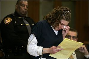 Elissa Schuster weeps as she reads a statement that reiterated her claim that she did not rape the girl, who is now 5.