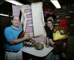 Gregg Kerns, left, president of Costume Holiday House Inc. in Fremont, and designer Alex Poznanski show some of their creations, including one from the 'Beauty and the Beast