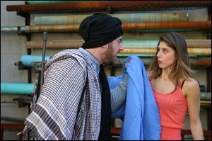 Brian Hillard plays a mullah and Elif Erturk is the daughter of
a woman who disappears in Afghanistan in the University of
Toledo s production of Homebody/Kabul.