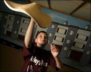 Josh Bailey, 10, won the inaugural junior division pizza tossing competition this summer using skills developed at his family s pizzeria.
