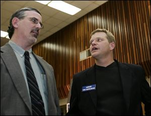 Toledo School Board candidate Steven Steel, left, and Judge Tim Kuhlman of Toledo Municipal Court chat while awaiting election returns last night at the UAW Local 12 hall.