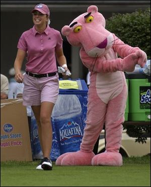 With pro golfer Paula Creamer, the Panther takes a practice swing at last year's Farr. 