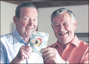 Harold C. Ackerman, left, and Ernie Bollinger hold the birthday card that they have been
sending to each other for more than 60 years.