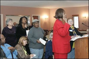 Jill Kelly, far right, director of the Lucas County Board of Elections, listens to poll worker Shirley Crenshaw discuss problems. 