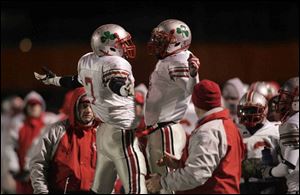 Chris Willis, left, and Neil Mitchell celebrate during the fourth quarter of Friday's state championship game. Willis and Mitchell shared the tailback job after Willis was slowed by an injury.