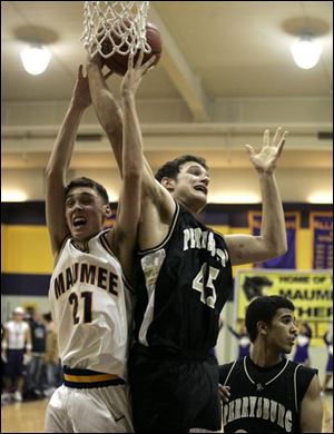 Maumee's Corey Nelson and Perrysburg's Glen Empie battle for a rebound. Empie had seven points and seven rebounds as the Yellow Jackets picked up a key Northern Lakes League win.