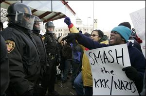 Protesters at the neo-Nazis' rally outside Government Center shout down police. Some in the crowd questioned the tactics used by law enforcement officers before and during the rally.