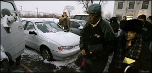 Dave Pifer auctions vehicles while Lester and Mary Calendar browse the Volunteers of America lot. A decline in automobile donations has especially hurt the Volunteers of America because its other funding sources have remained flat for years.