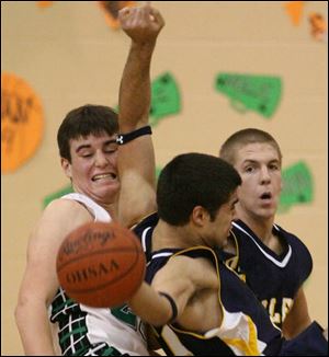 Ottawa Hills' Andrew Parker, left, and Toledo Christian's 
Andrew Mawer collide last night in TAAC basketball action.