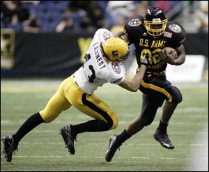 East running back Chris Wells of Akron Garfield scored three TDs and was named MVP in the All-American Bowl.