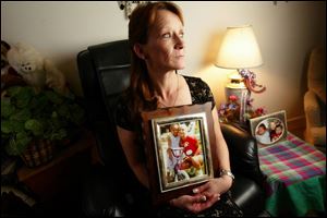 Nadine Fechtner holds a picture of her late daughter, Buffie Rae Brawley, and Ms. Brawley's daughter, Ebony.