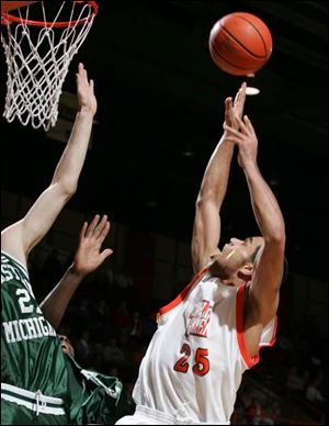 Bowling Green's Martin Samarco soars over a pair of Eastern Michigan defenders.