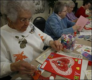 Helen Zimmerman, from left, Ethel Kissel, and Katie Sanders work on valentines to be traded to pen pals who are third graders at Elm Street Elementary School.