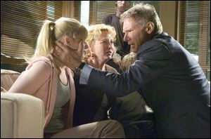 Jack (Harrison Ford) reassures his family (from left, Carly Schroeder,
Virginia Madsen, and a partially obscured Jimmy Bennett).
