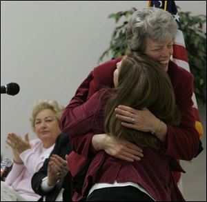 Hope Taft hugs Kris Washington, a regional coordinator at the Wood County Educational Service Center in Bowling Green, where Mrs. Taft addressed substance abuse prevention specialists. She said she hopes communities join in the effort.