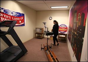 Amy Finkbeiner, wife of Mayor Carty Finkbeiner, shows off some of the changes the mayor has made to his office arae on the 22nd floor of Toledo's One Government Center.