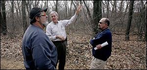 John Yaeger points to some of nature's details in a walk with Bill Tunison, left, and Administrator Bob Anderson through Springfield Township's new park off Angola Road.