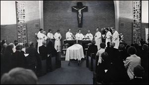 Priests, including the Rev. Gerald Robinson, center under the crucifi x, celebrate the funeral Mass for Sister Margaret Ann Pahl.
