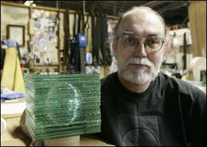 Bernie Andrews, of Andrews' Art Glass Art in East Toledo, takes a time out with his sculpture. 