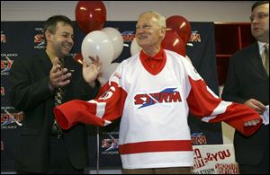 Coach Nick Vitucci, left, and GM Pat Pylypuik don't seem to care Mayor Carty Finkbeiner's Storm sweater is a mite too big.