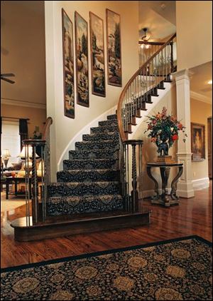 A patterned carpet or runner on a staircase can jazz up a foyer.