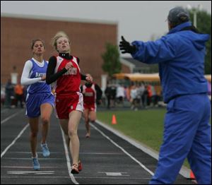 Bowling Green s Christy Titus repeats as champion in the 1600 race, edging Anthony Wayne s Ashley Evens yesterday in the NLL meet. Titus also won the 3200 for the Bobcats.
