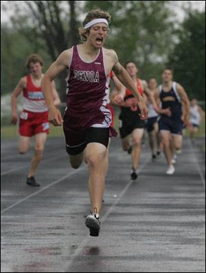 Genoa's Alex Peters leaps over the finish line to win the 800-meter race yesterday in the SLL meet. The senior also won the 1600.