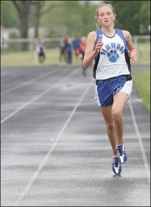 Elmwood freshman Kaye Bockbrader has a commanding lead as she finishes to win the 3200-meter race in the SLL championships.