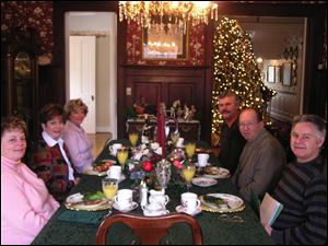 Three couples visiting from Canada settle in for breakfast at the Georgian Manor Inn.  