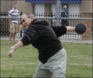 Jack Ragan of Swanton warms up with the discus before his event at the 50+ Sports Classic. Mr. Ragan was one of more than 110 people 50 and over to compete in the annual event.