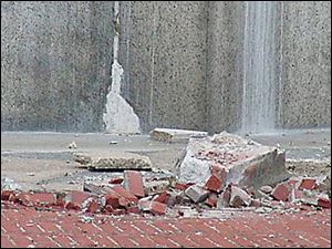 Pieces of granite that broke off, falling 315 feet onto the 
concrete plaza, right. The impact created a crater.