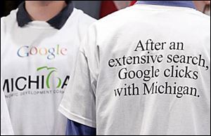 Attendees at the news conference in Lansing, Mich., announcing the move sport celebratory T-shirts.