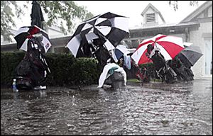 Water pools near the clubhouse yesterday at Highland Meadows where the National City Celebrity Pro-Am was washed out and the practice tee was closed.