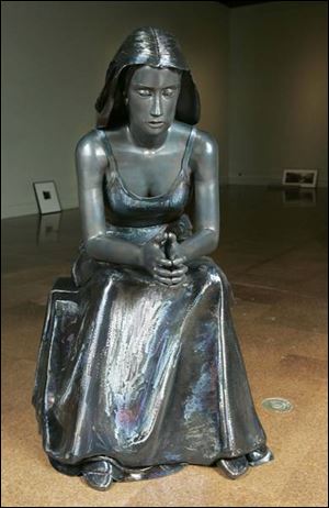 Jamie Goode's <i>Contemplation</i> shows a seated woman.