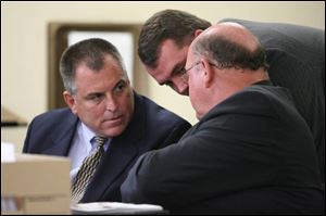 Tom Noe, left, confers with attorneys John Mitchell, center, and Bill Wilkinson during a hearing in front of Judge Thomas Osowik yesterday. The hearing continues today.