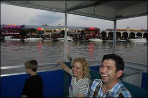 Bill and Lori Heninger enjoy a ride aboard a water taxi on the Maumee River with their 7-year-old son, Zach.