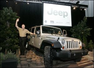 Tom LaSorda, president and CEO of Chrysler Group, stands next to the new five-passenger Wrangler Rubicon Unlimited.
